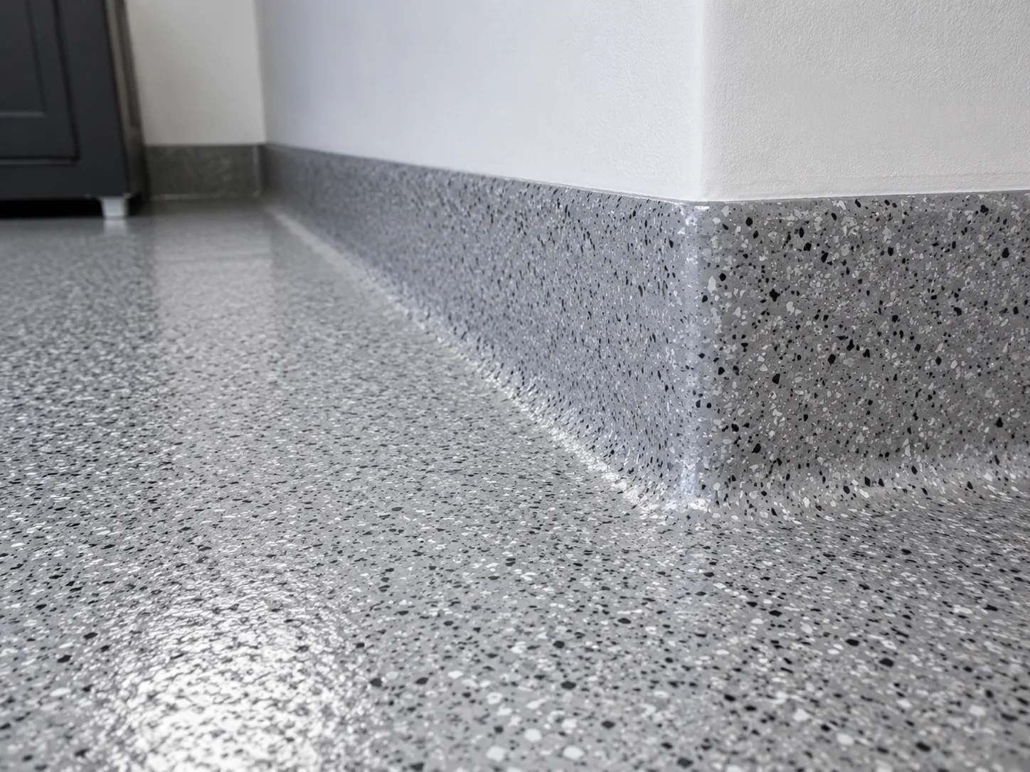 Coved epoxy base where floor meets wall